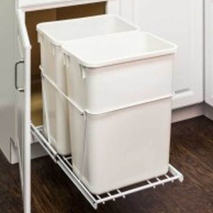 two garbage cans on a slider that slides into a cabinet